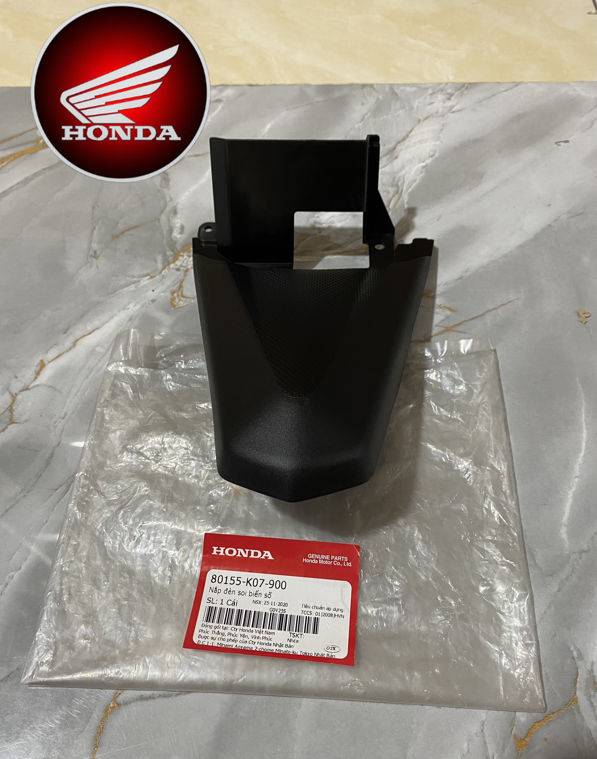 Nắp đèn soi biển số WAVE RSX 110 2012 màu đen (80155K07900)